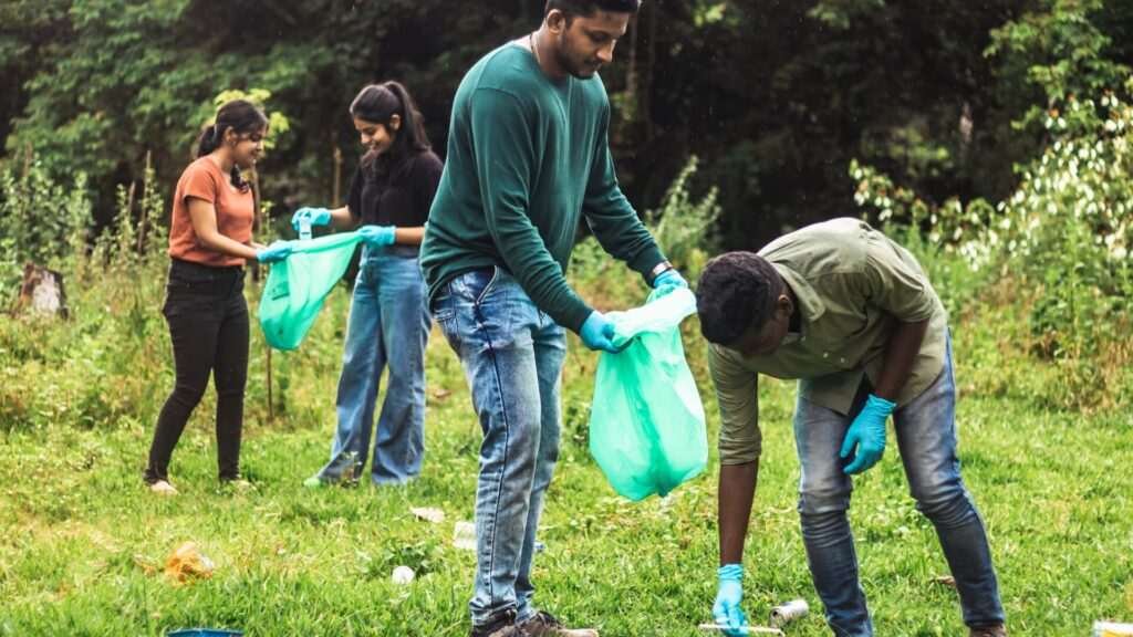 Volunteers cleaning up park by collecting trash