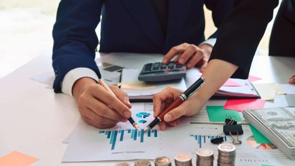 Business team analyzing financial graphs and data