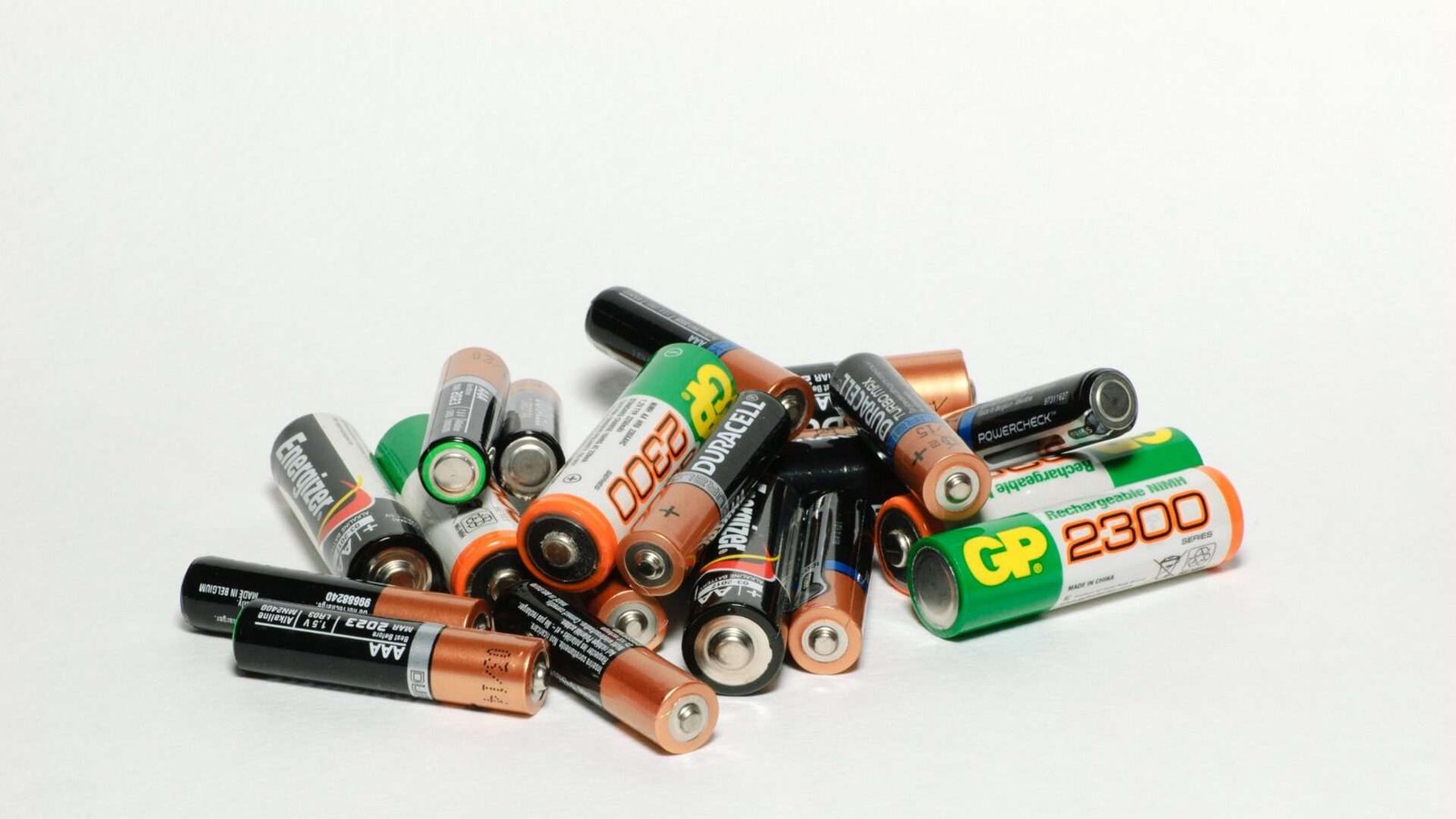 Various types of batteries on white background