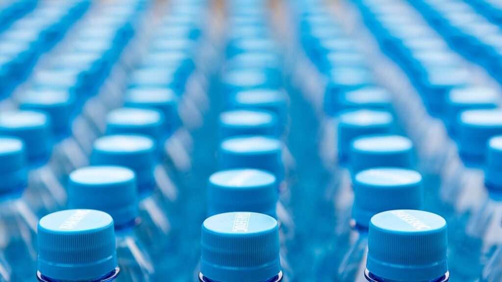 Rows of blue plastic water bottle caps.